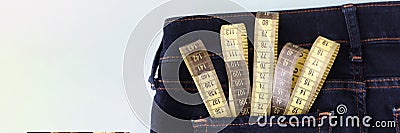 Yellow measuring tape in jeans pocket image of body slimming Stock Photo