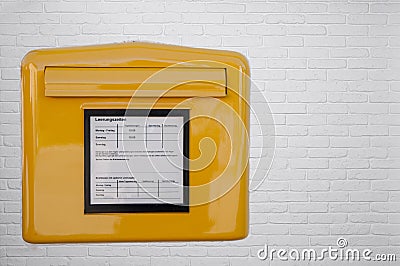 German mailbox on white brick wall Stock Photo