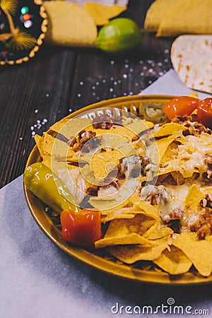close up yellow mexican nachos plate butter paper. High quality photo Stock Photo