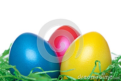 Close-up of yellow, red, blue Easter Eggs in nest Stock Photo