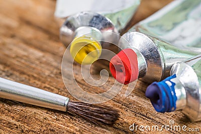 Close up of Yellow,Red,Blue, Tempera color with paint brush on wood texture Stock Photo