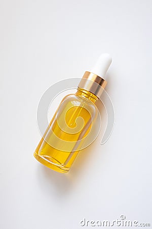 Close-up yellow serum essence in glass bottle. Isolated skincare oil Stock Photo