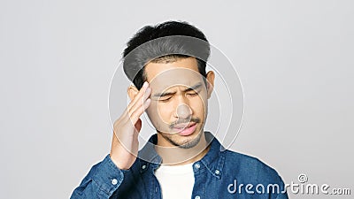 Close up of young asian man doubting while standing over grey background, Portrait of confused handsome asia guy, People Stock Photo