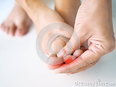 Close-up young asian woman with painful and inflamed on toe of foot, medical symptom and healthcare concept Stock Photo