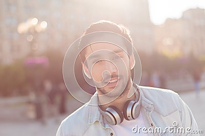 Close up of a young attractive brunete guy, walking in the city Stock Photo