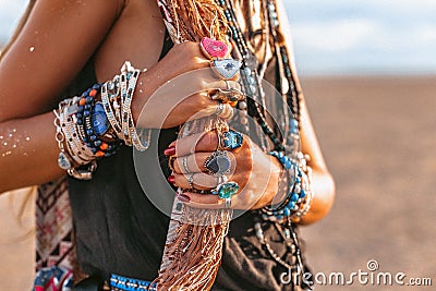 Close up of young boho style woman hands with lots of accessories Stock Photo