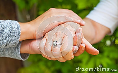 Holding hands, Parkinson disease Stock Photo