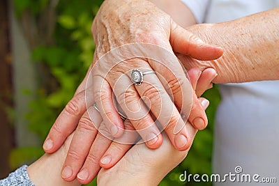 Holding hands, Parkinson disease Stock Photo