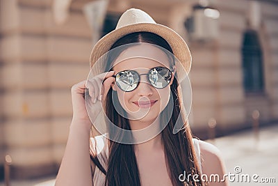 Close up of young cute smiling girl in mirror sunglasses and hat Stock Photo