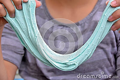 Girl stretching aqua slime Stock Photo