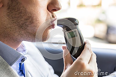 Man Sitting Inside Car Taking Alcohol Test Stock Photo