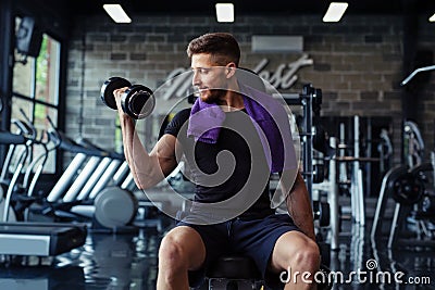 Close Up of a muscular young man lifting weights in gym Stock Photo