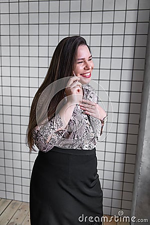 Close up Young Office Woman Talking to Someone on her Mobile Phone While Looking Into the Distance with Happy Facial Stock Photo