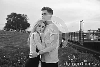 Close-up of young romantic couple is kissing and enjoying the company of each other in black and white. Young couple in love Stock Photo
