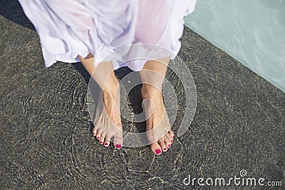 young woman escaping heat wave in city fountain Stock Photo