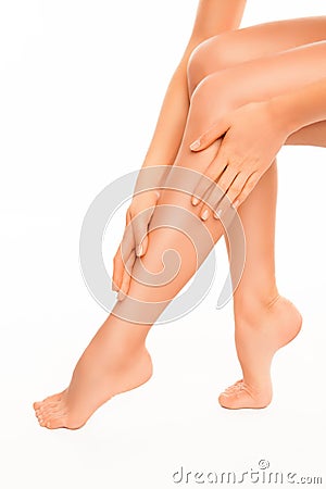 Close up of young woman massaging her healthy legs Stock Photo