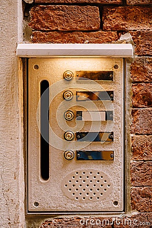 Close-ups of building facades in Venice, Italy. An old vintage intercom and a mailbox on a stone wall. On door where Stock Photo