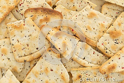 Close view of broken seasoned pizza crust chips Stock Photo