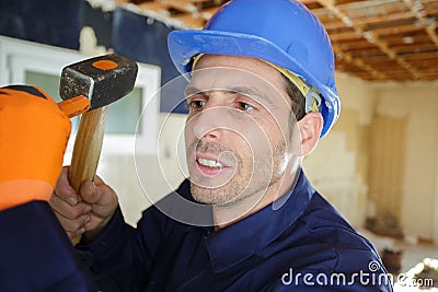 Close view builder using hammer chisel Stock Photo
