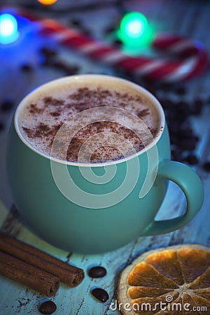 Close view cappuccino in green mug with christmas decoration and candies. Orange and candy Stock Photo