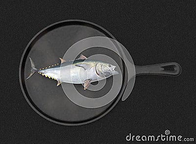 Close view of a fish on a heavy metal skillet Stock Photo