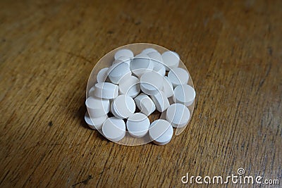 Close view of handful of white pills Stock Photo