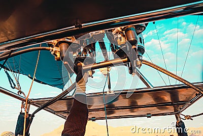 Close view of the propane burner torch on an air balloon. Pilots hand on the lever used for piloting the air balloon Stock Photo