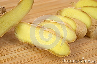 Close view sliced ginger root on cutting board Stock Photo