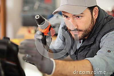 close view workman using cordless screwdriver Stock Photo