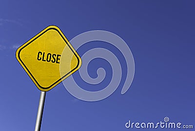 Close - yellow sign with blue sky background Stock Photo