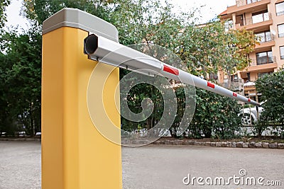 Closed automatic boom barrier on autumn day outdoors Stock Photo