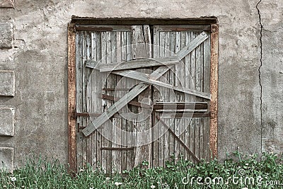 Closed, boarded-up old wooden door. Old abandoned house. Stock Photo