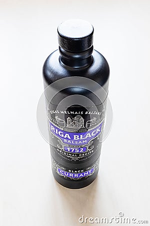 Closed bottle of Riga Black Balsam on pale table Editorial Stock Photo