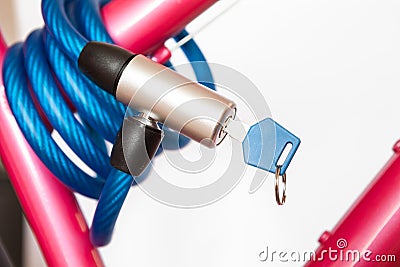 Closed cable lock with permanently integrated locking mechanism, looped cable, white background Stock Photo