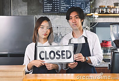 Closed coffee shop A young couple man and female overturned a label to close they business because of loss in selling coffee Stock Photo