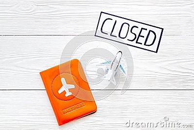 Closed counrty borders - coronovirus quarantine. Airplane and passport on white wooden background top view Stock Photo