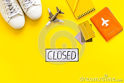 Closed counrty borders - coronovirus quarantine. Airplane and passport on yellow background top view Stock Photo