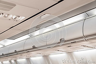 Closed doors luggage shelves in economy class passenger aircraft Stock Photo