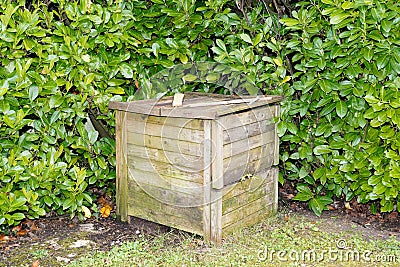 Closed ecological wood compost bin with organic material Stock Photo