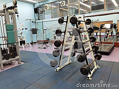 3 11 2021 closed and empty sport center with Modern light gym, equipment, Barbells of different weight on rack in university of Editorial Stock Photo