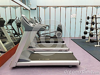 3 11 2021 closed and empty sport center with Modern light gym, equipment, Barbells of different weight on rack in university of Editorial Stock Photo