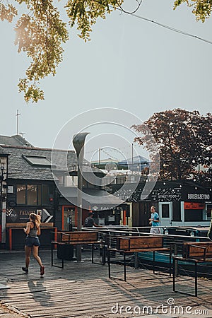 Closed food stalls in Camden Market, London, UK, people running past Editorial Stock Photo