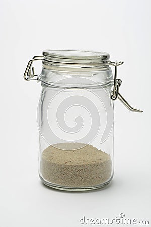Closed glass jar with sand Stock Photo
