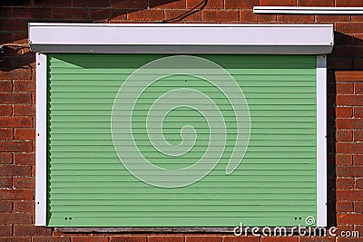 Closed green security shutters Stock Photo