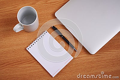 Closed Laptop Beside Empty Journal With Pen And Coffee Mug Over Table. Notebook Computer With Blank Notepad Ballpen Stock Photo