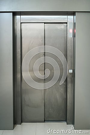 closed metallic dirty lift door Stock Photo