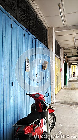 Closed old shops with motorbike Editorial Stock Photo