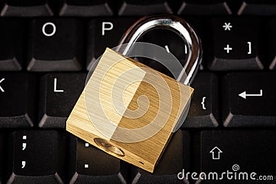 Closed padlock on a black computer keyboard Stock Photo