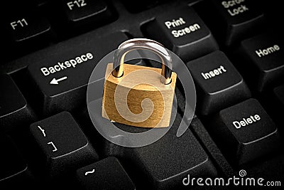 Closed padlock on a black keyboard Stock Photo