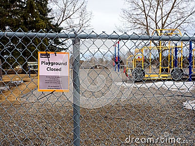 Closed Playground sign on a fence due to Covid 19 pandemic Editorial Stock Photo